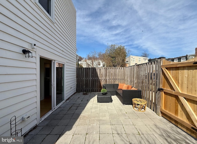 view of patio with outdoor lounge area, a gate, and a fenced backyard