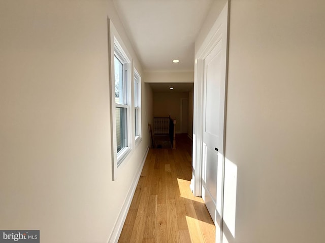 hallway featuring recessed lighting, baseboards, and light wood-style floors