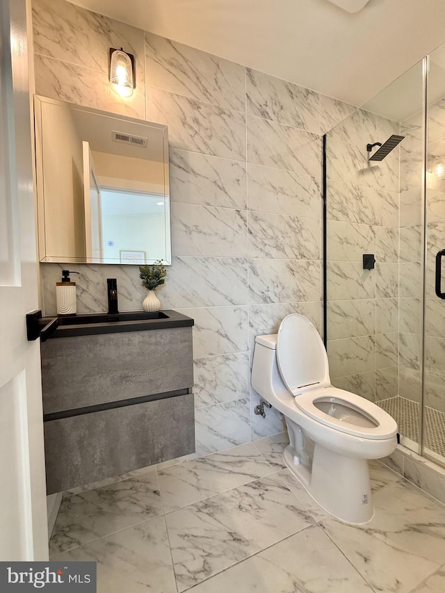 bathroom with visible vents, a shower stall, toilet, marble finish floor, and vanity