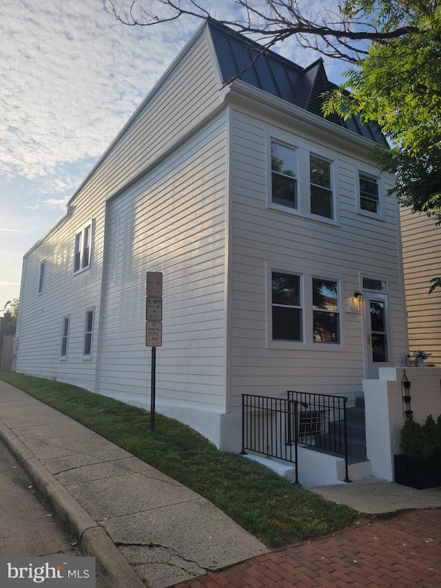 view of home's exterior with a standing seam roof and metal roof