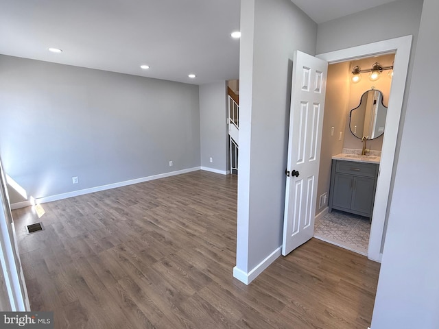 interior space with a fireplace, recessed lighting, dark wood-style floors, and baseboards