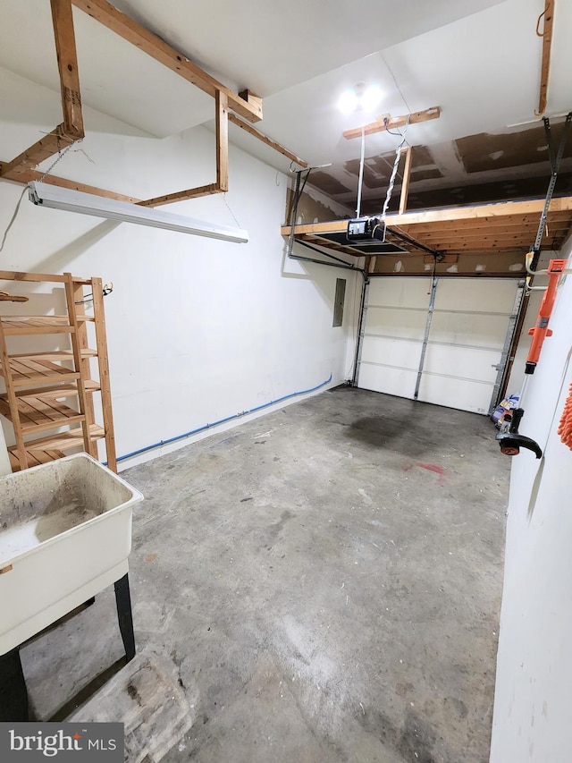 garage with a garage door opener and a sink