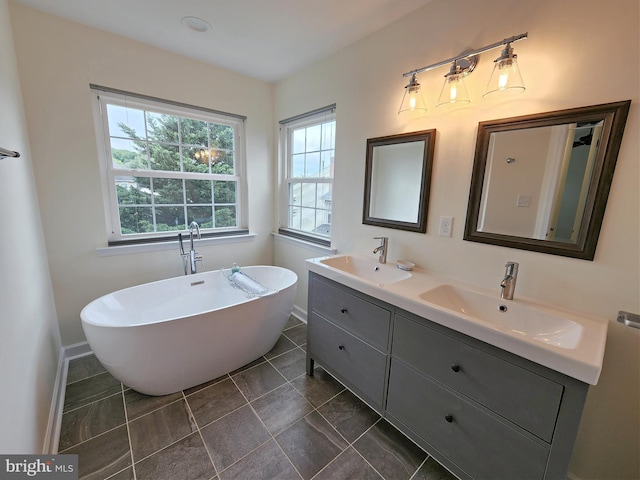 bathroom with a sink, a soaking tub, and double vanity