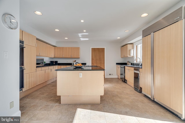 kitchen featuring dark countertops, light brown cabinets, a kitchen island, recessed lighting, and black appliances