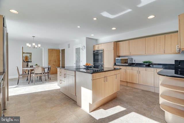 kitchen with light brown cabinets, a kitchen island, recessed lighting, stainless steel microwave, and a chandelier