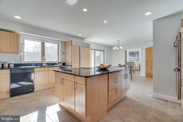 kitchen with black appliances, light brown cabinets, a sink, dark countertops, and a center island