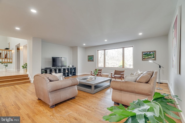 living room featuring stairs, recessed lighting, light wood-type flooring, and baseboards