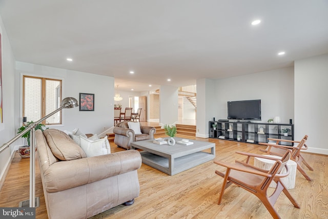 living room with stairway, recessed lighting, baseboards, and wood finished floors