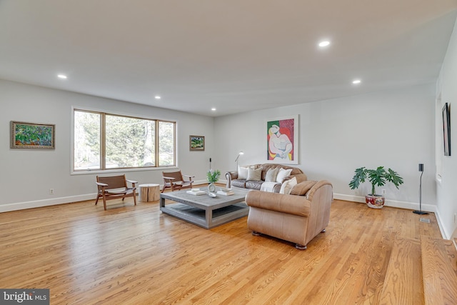 living area featuring light wood finished floors and recessed lighting