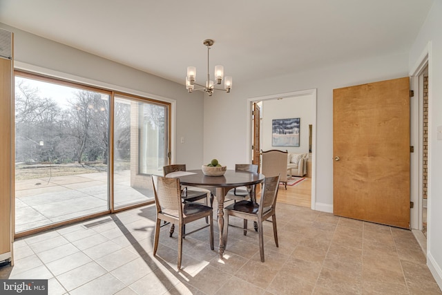 dining space with visible vents, baseboards, and a notable chandelier