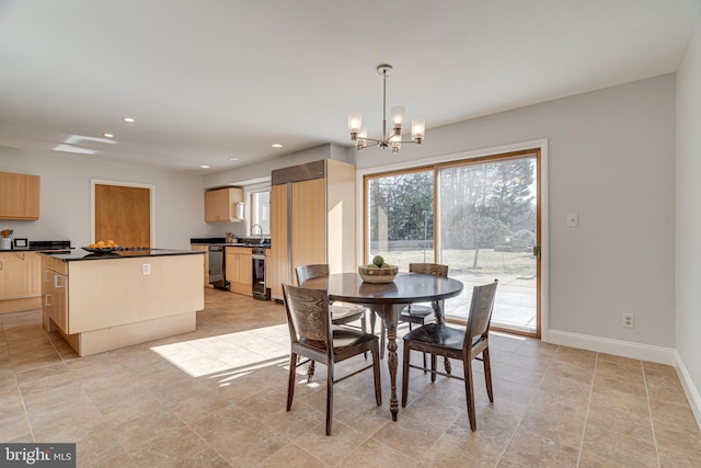 dining room with recessed lighting, baseboards, wine cooler, and a chandelier