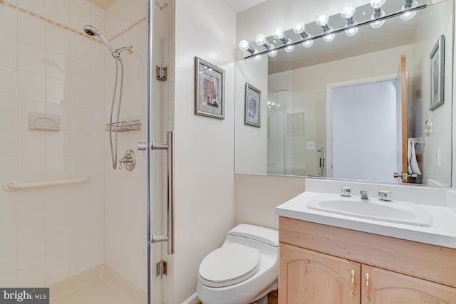 full bath featuring toilet, a stall shower, and vanity