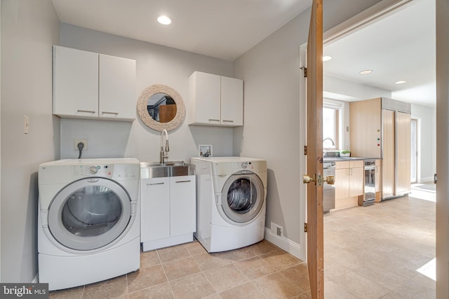 laundry area featuring a sink, recessed lighting, cabinet space, hookup for an electric dryer, and hookup for a washing machine