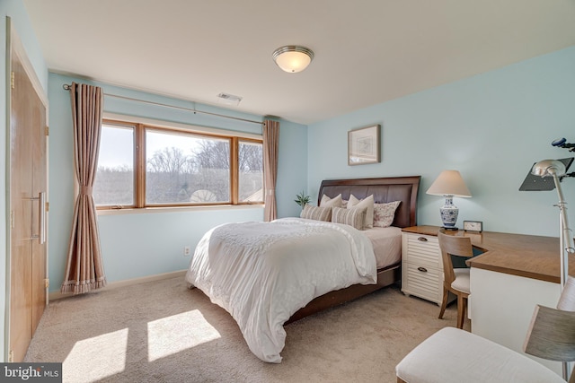 bedroom featuring visible vents, light carpet, and baseboards