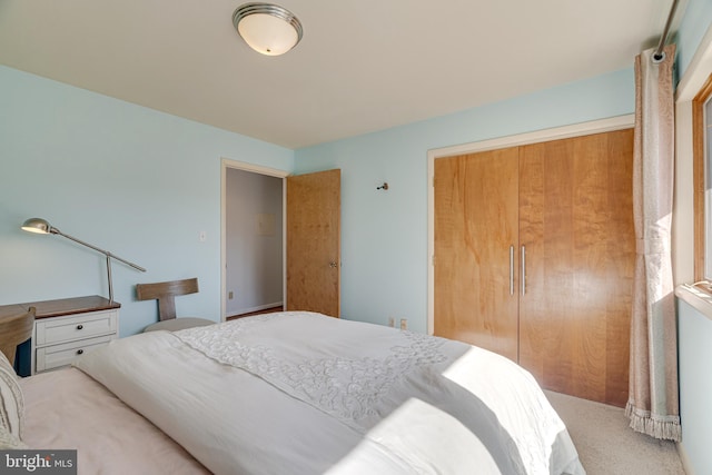 bedroom featuring a closet and light carpet