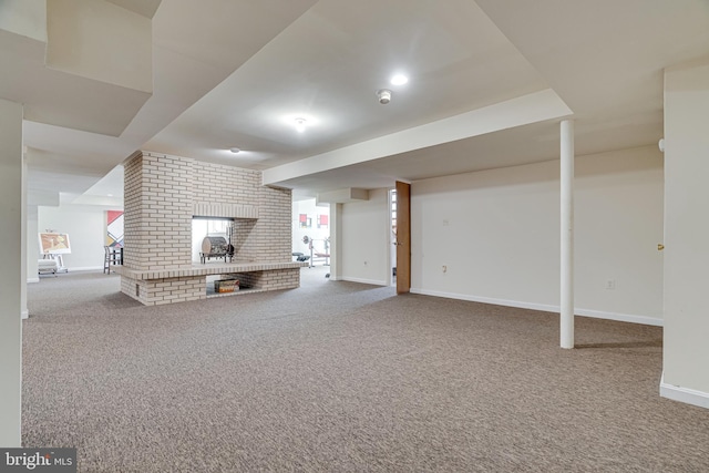 basement with carpet flooring, a fireplace, and baseboards