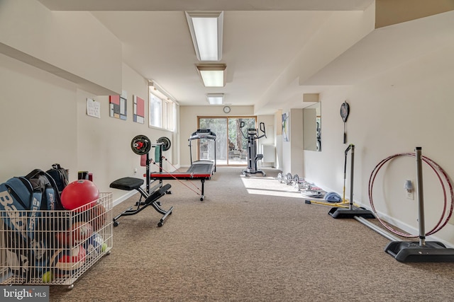 workout room with baseboards and carpet