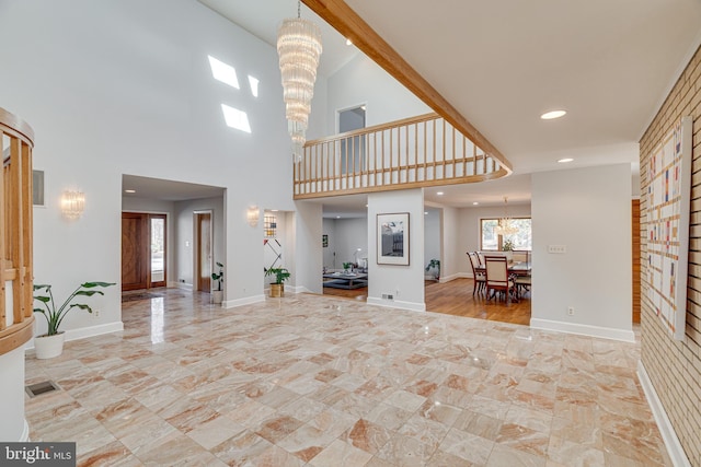 unfurnished living room with recessed lighting, visible vents, baseboards, and a notable chandelier