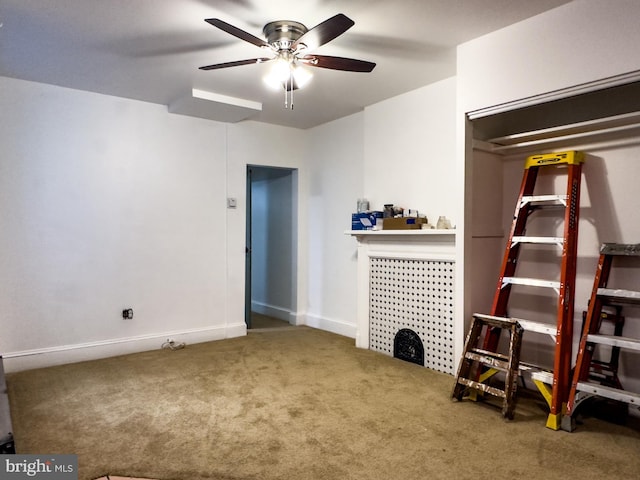 interior space featuring carpet flooring, ceiling fan, and baseboards