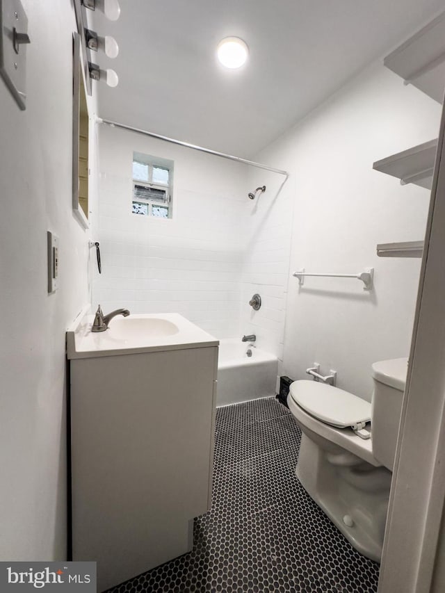 bathroom with tile patterned flooring, tub / shower combination, toilet, and vanity