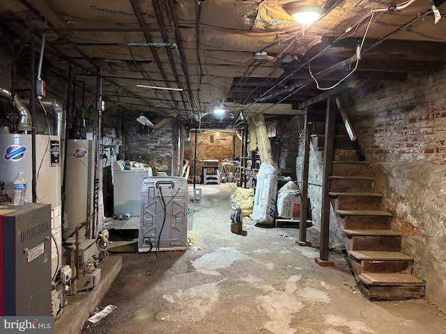 unfinished basement with gas water heater, washer / clothes dryer, stairs, and water heater