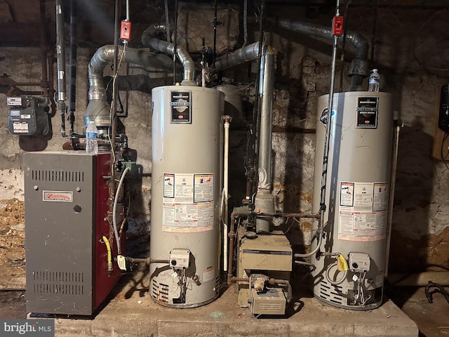 utility room featuring gas water heater and a heating unit