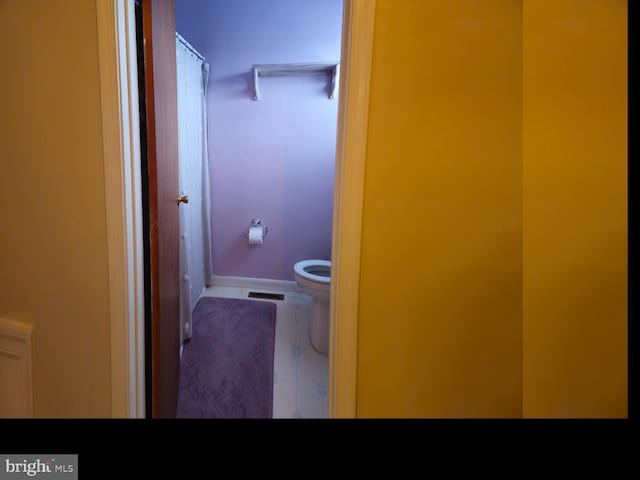 bathroom with visible vents, baseboards, toilet, and tile patterned flooring