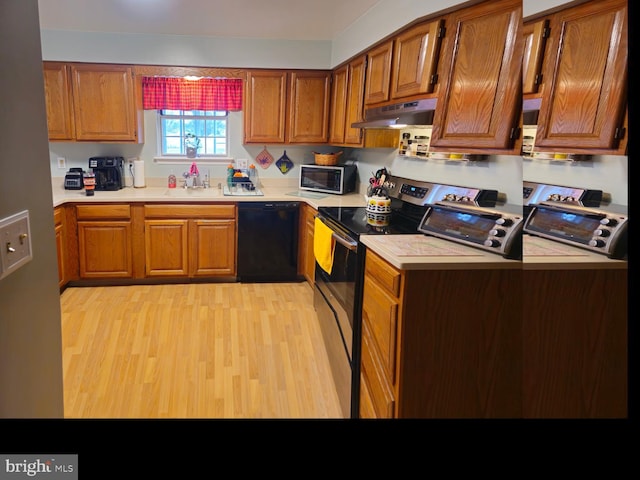 kitchen featuring under cabinet range hood, a sink, stainless steel electric range, light countertops, and dishwasher