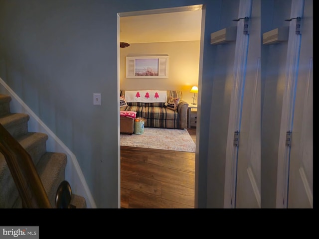 hallway featuring stairway and wood finished floors