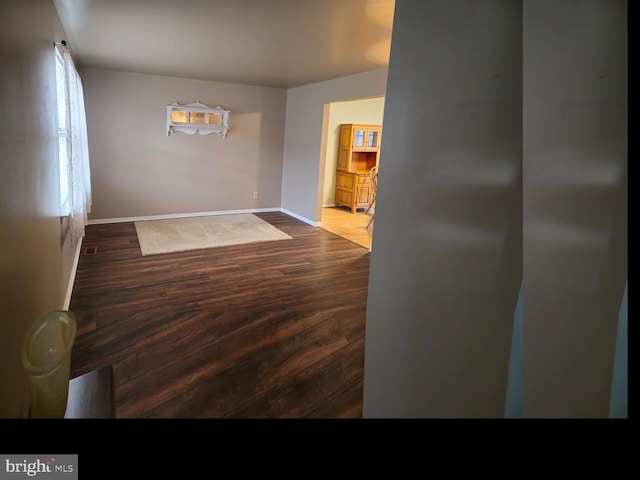 interior space with baseboards and wood finished floors