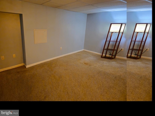 unfurnished room featuring a paneled ceiling and baseboards