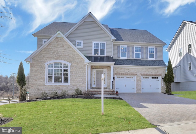 view of front of house with brick siding, a front yard, roof with shingles, decorative driveway, and an attached garage