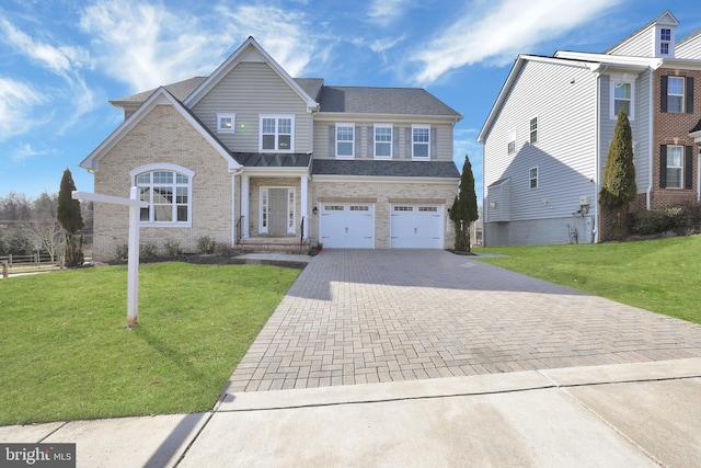 traditional-style home featuring decorative driveway, a front yard, an attached garage, and brick siding