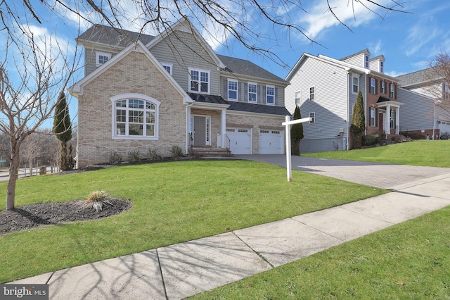 view of front of house with a front lawn, a garage, brick siding, and driveway