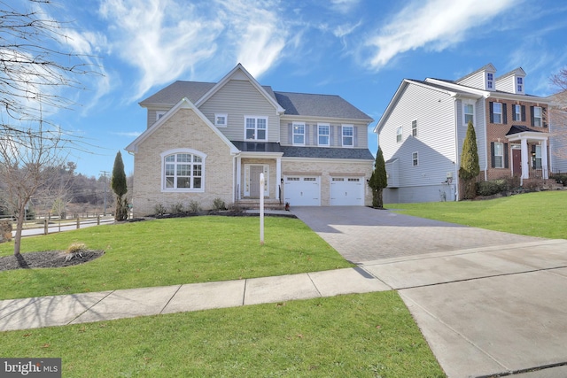 view of front facade featuring brick siding, an attached garage, driveway, and a front lawn