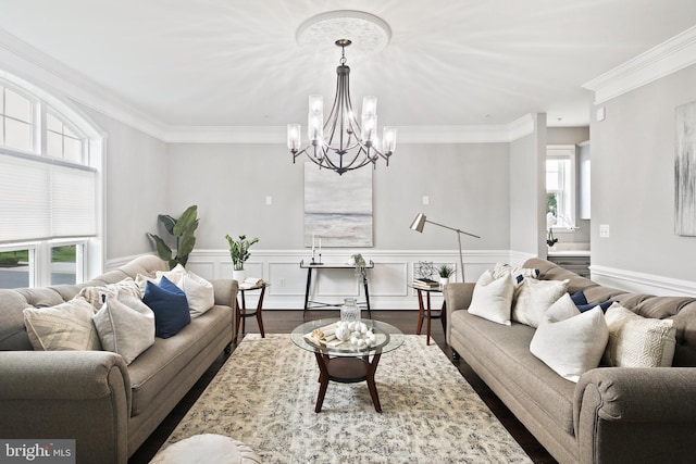 living room featuring a wainscoted wall, a decorative wall, dark wood-style flooring, and ornamental molding