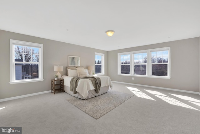 carpeted bedroom featuring baseboards