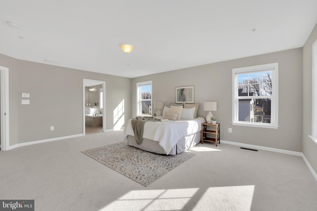 carpeted bedroom featuring baseboards and visible vents