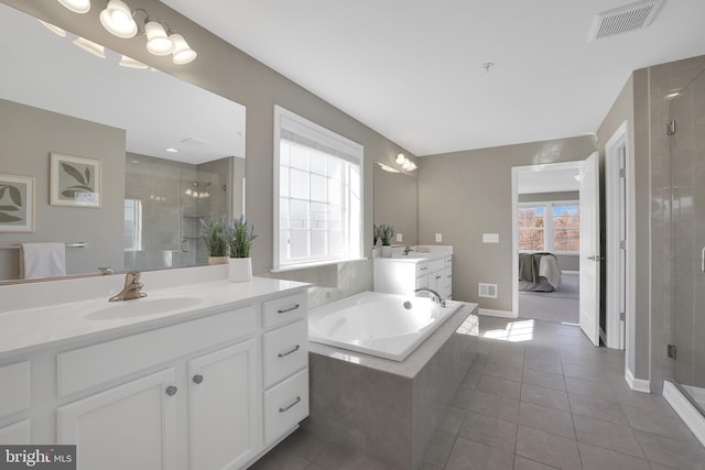 bathroom with tile patterned floors, visible vents, a shower stall, and a sink