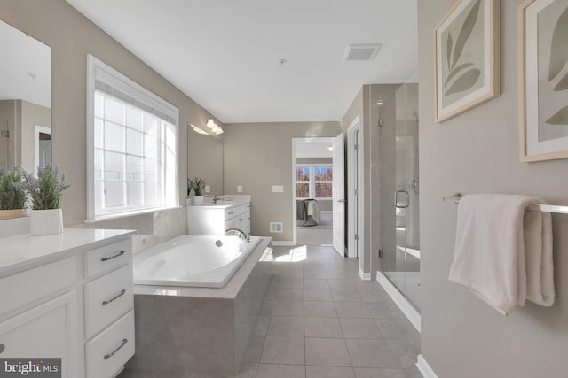 full bath featuring tile patterned floors, a bath, visible vents, and a stall shower