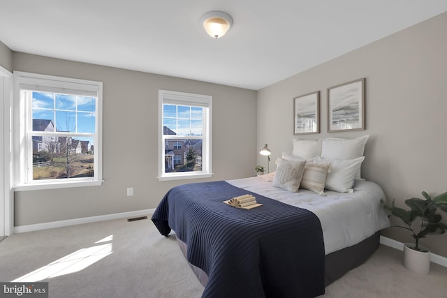 bedroom featuring visible vents, carpet flooring, and baseboards