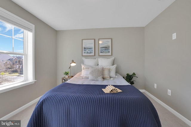 carpeted bedroom featuring baseboards