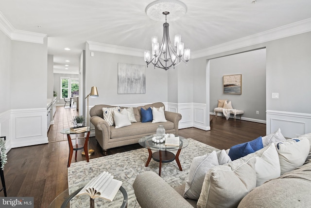 living area featuring wainscoting, a decorative wall, ornamental molding, and wood finished floors