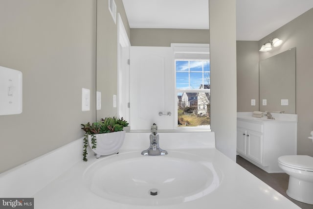 bathroom featuring toilet and vanity