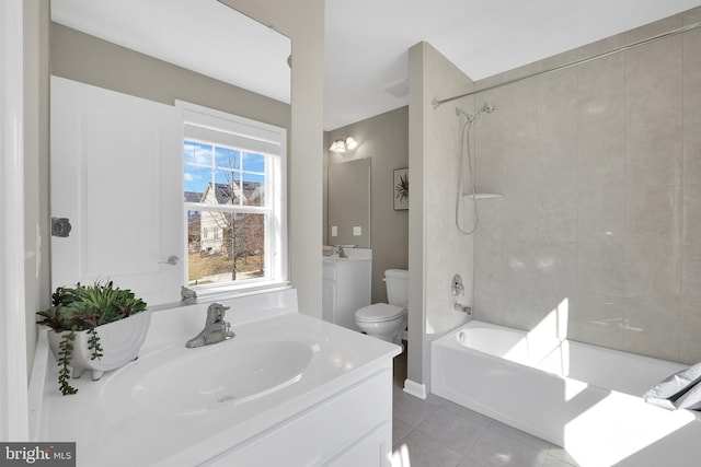 bathroom featuring tile patterned flooring, toilet, vanity, and bathtub / shower combination