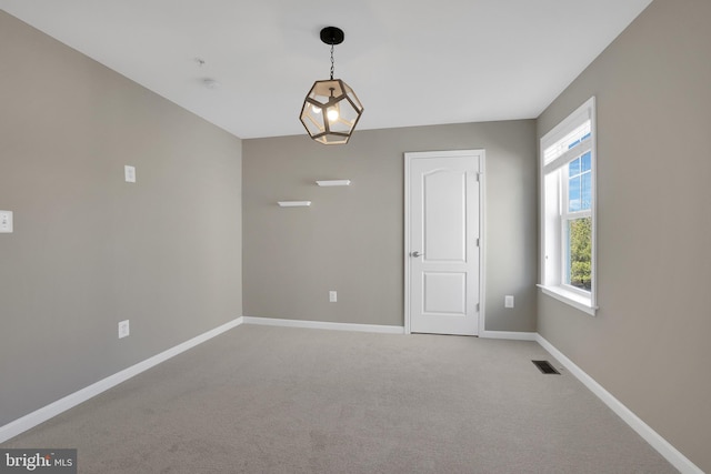 empty room featuring visible vents, baseboards, and light carpet