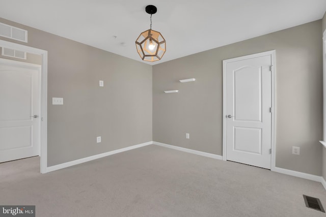 unfurnished room featuring carpet, baseboards, and visible vents