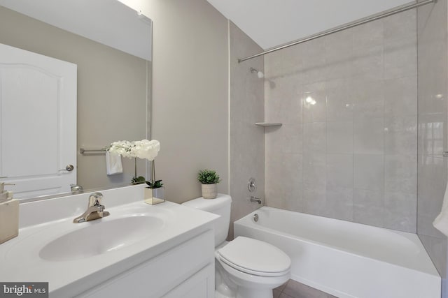 bathroom with toilet, vanity, and  shower combination