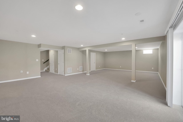 below grade area with visible vents, recessed lighting, stairs, and baseboards