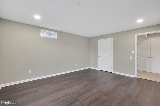 unfurnished bedroom with recessed lighting, dark wood-style floors, and baseboards